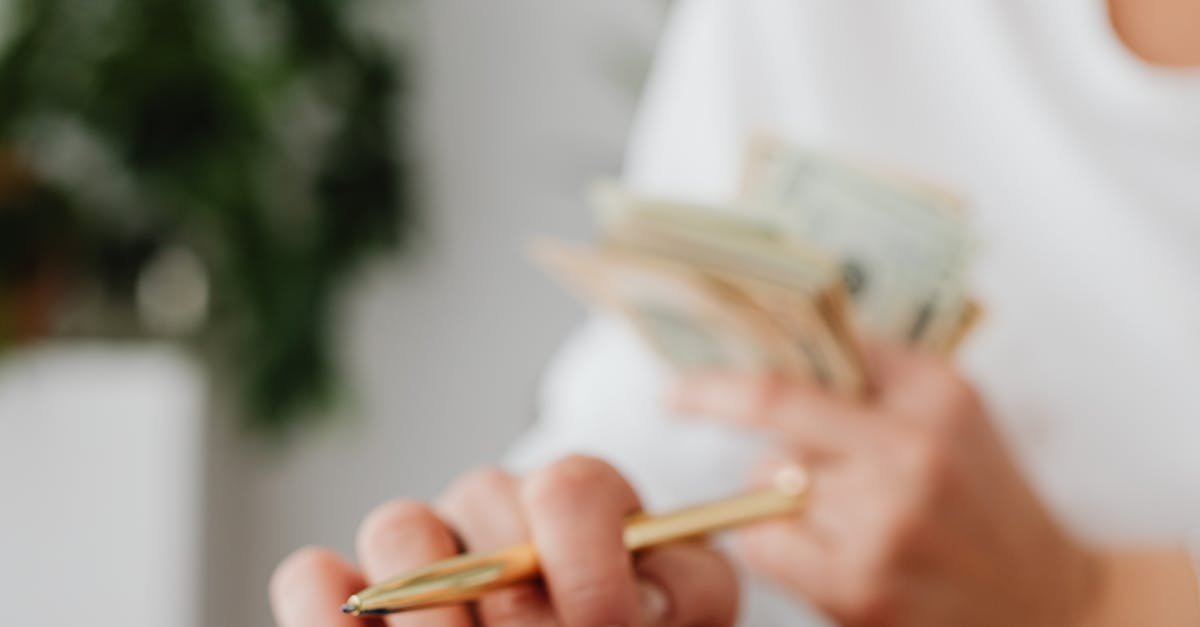 A woman uses a calculator and holds money, illustrating personal finance management.